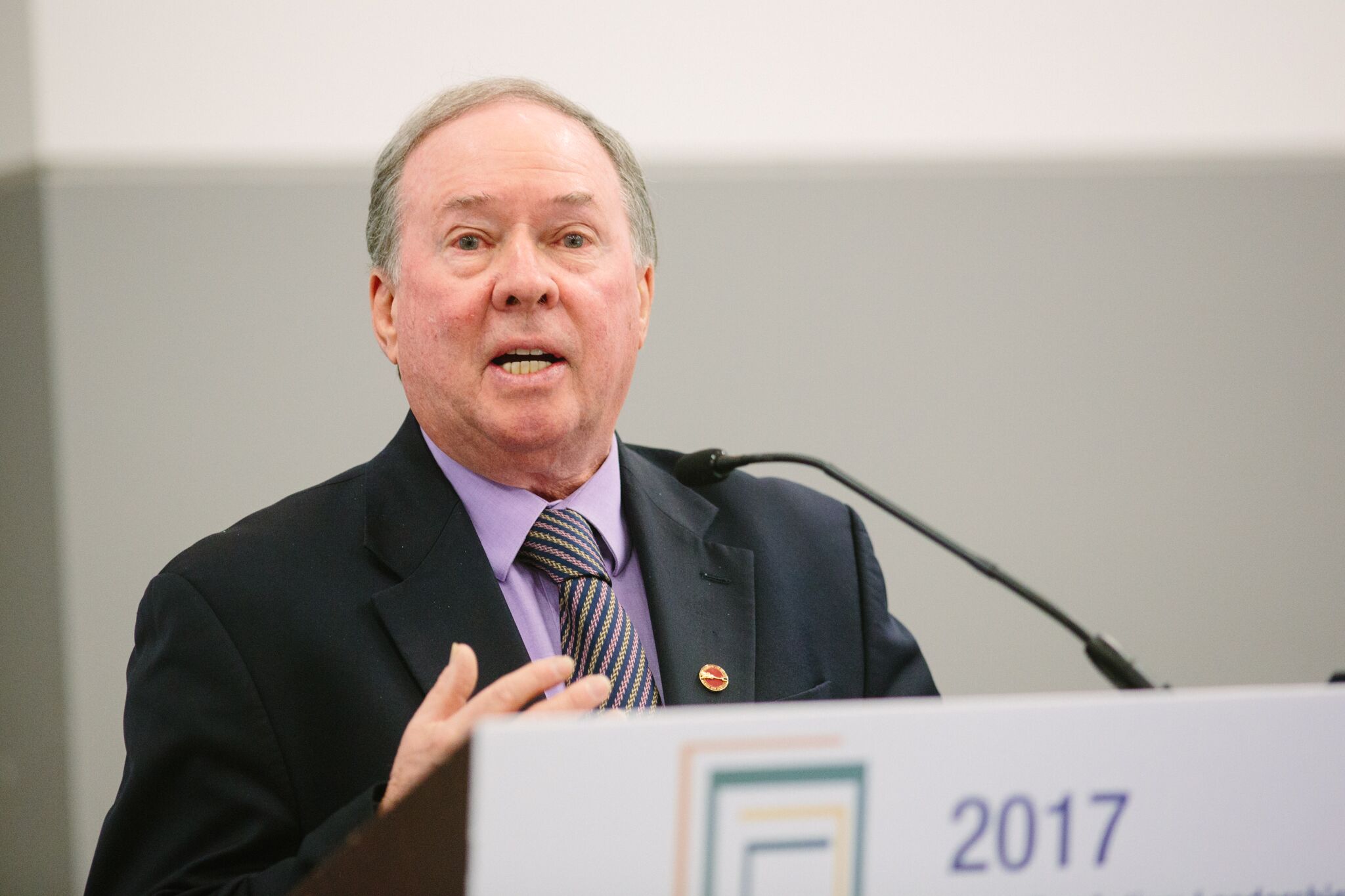 The Honourable Jim Munson speaking at a podium.